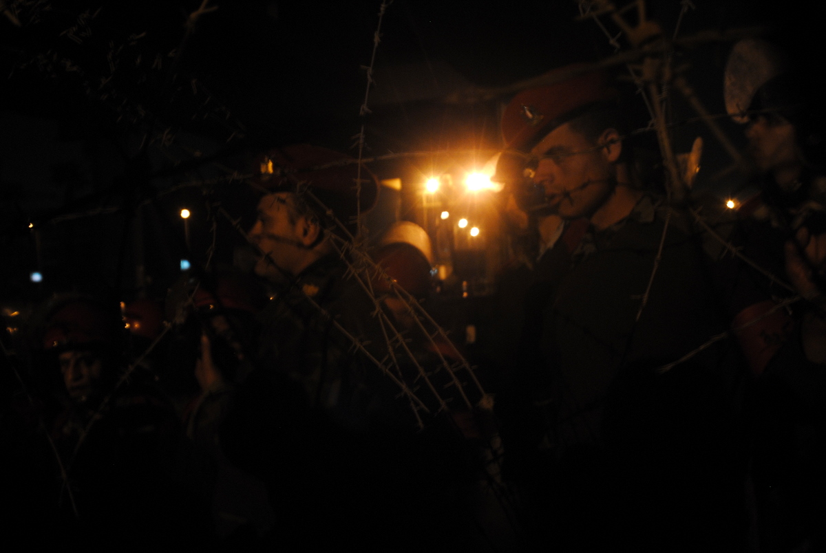 several people standing together in the dark with a bright light