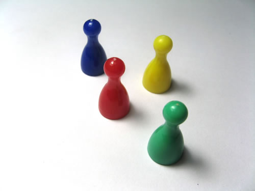 a set of small toy figures sit on a white table