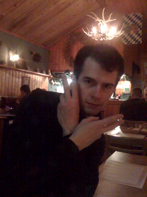 a man giving the number one sign in a restaurant