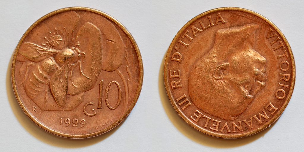 two old copper coins sit next to each other