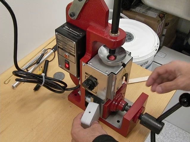 a person operating a vice with a drill gun
