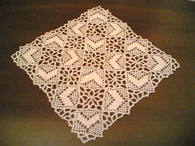 white doily on a wooden table top