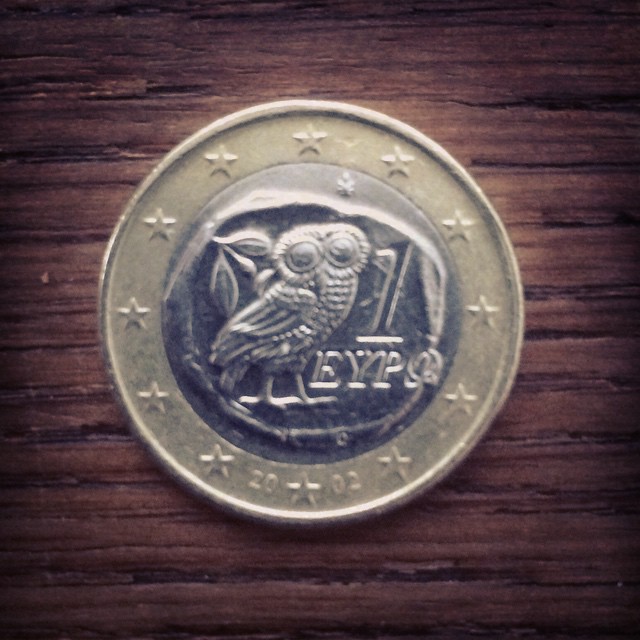 an egyptian coin sitting on top of a wooden table