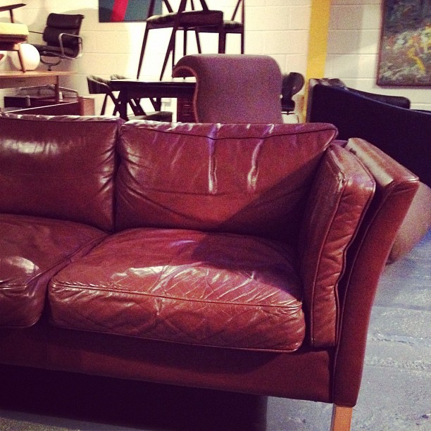 a brown leather couch in a store display area