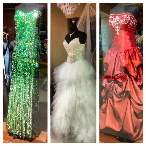 several different types of dresses on display in a window