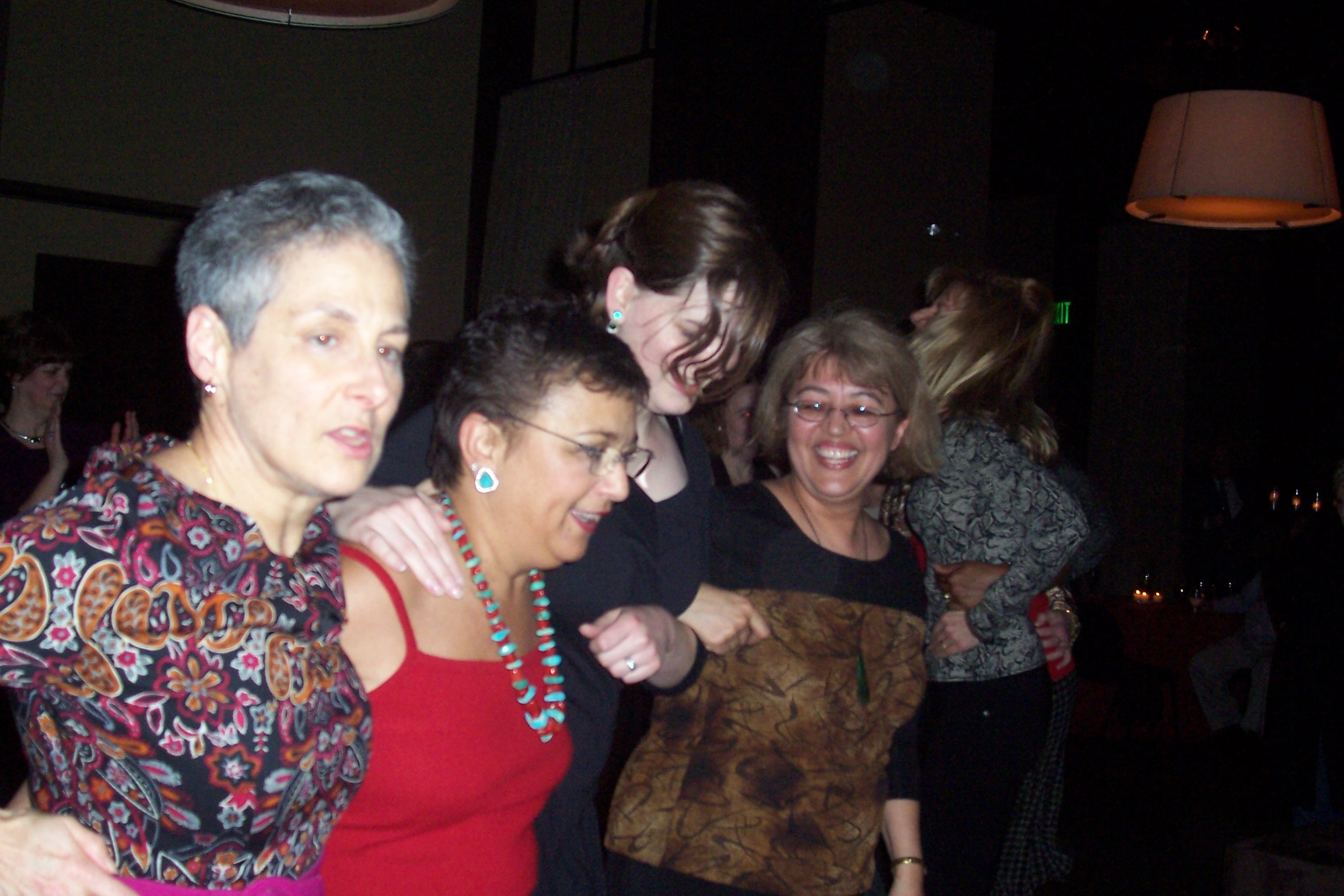 a group of women standing around each other