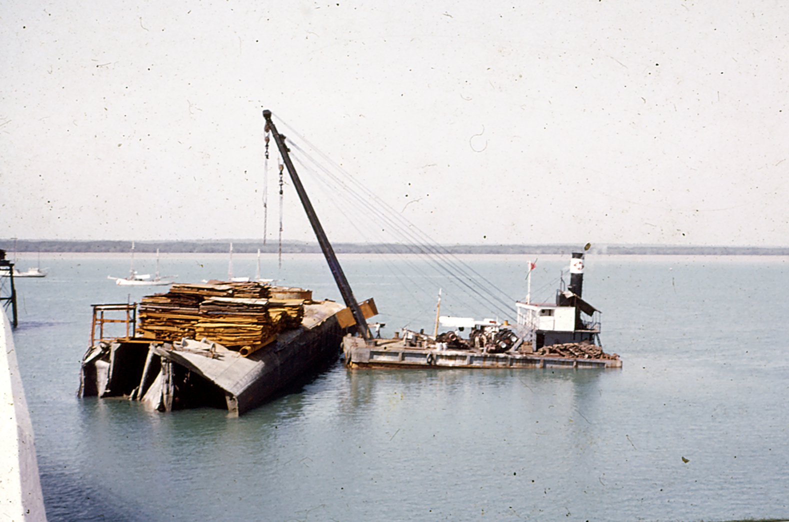 a crane on top of a barge in the water