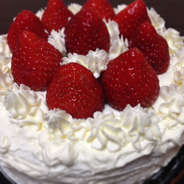 a cake with white icing and strawberries on top