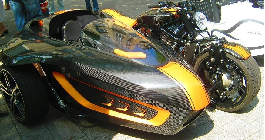 a motorcycle with orange and black stripes parked