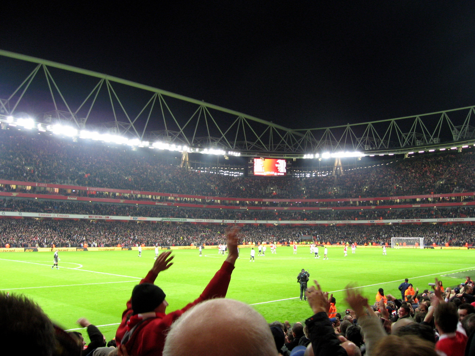 a group of people in the stadium playing soccer