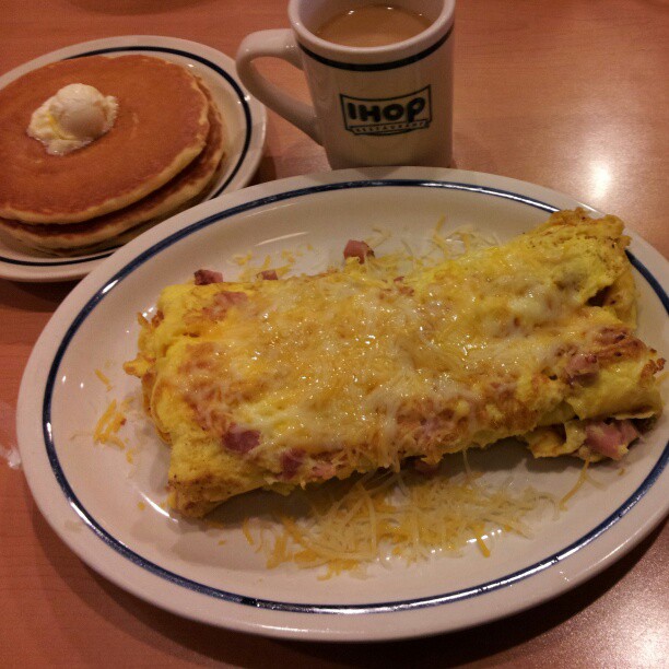 a breakfast consisting of two pancakes and omelets
