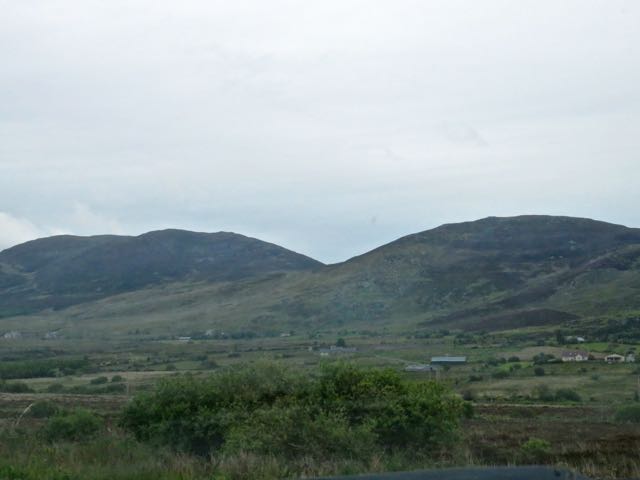 some hills that have a house on them