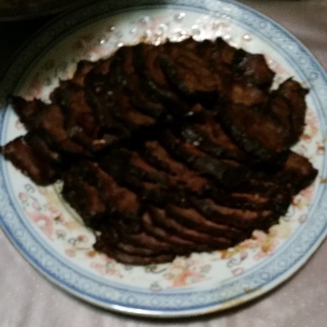 a plate of slices of meat sitting on a table