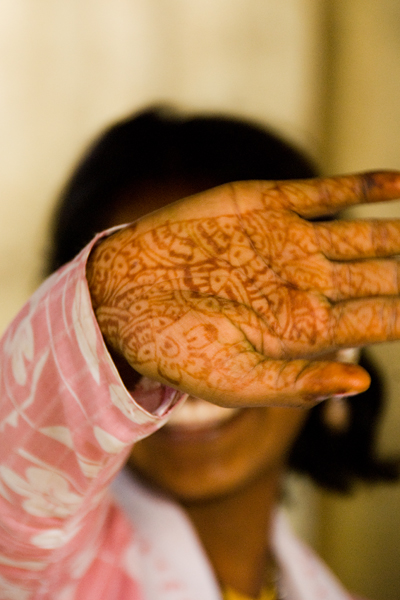 a girl with a hendi showing the intricate pattern of her hand