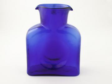 a bright blue glass vase on white background