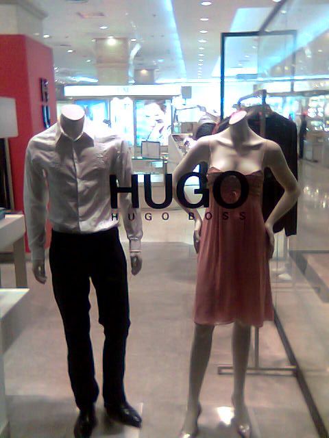 man and women's clothing displayed in window display
