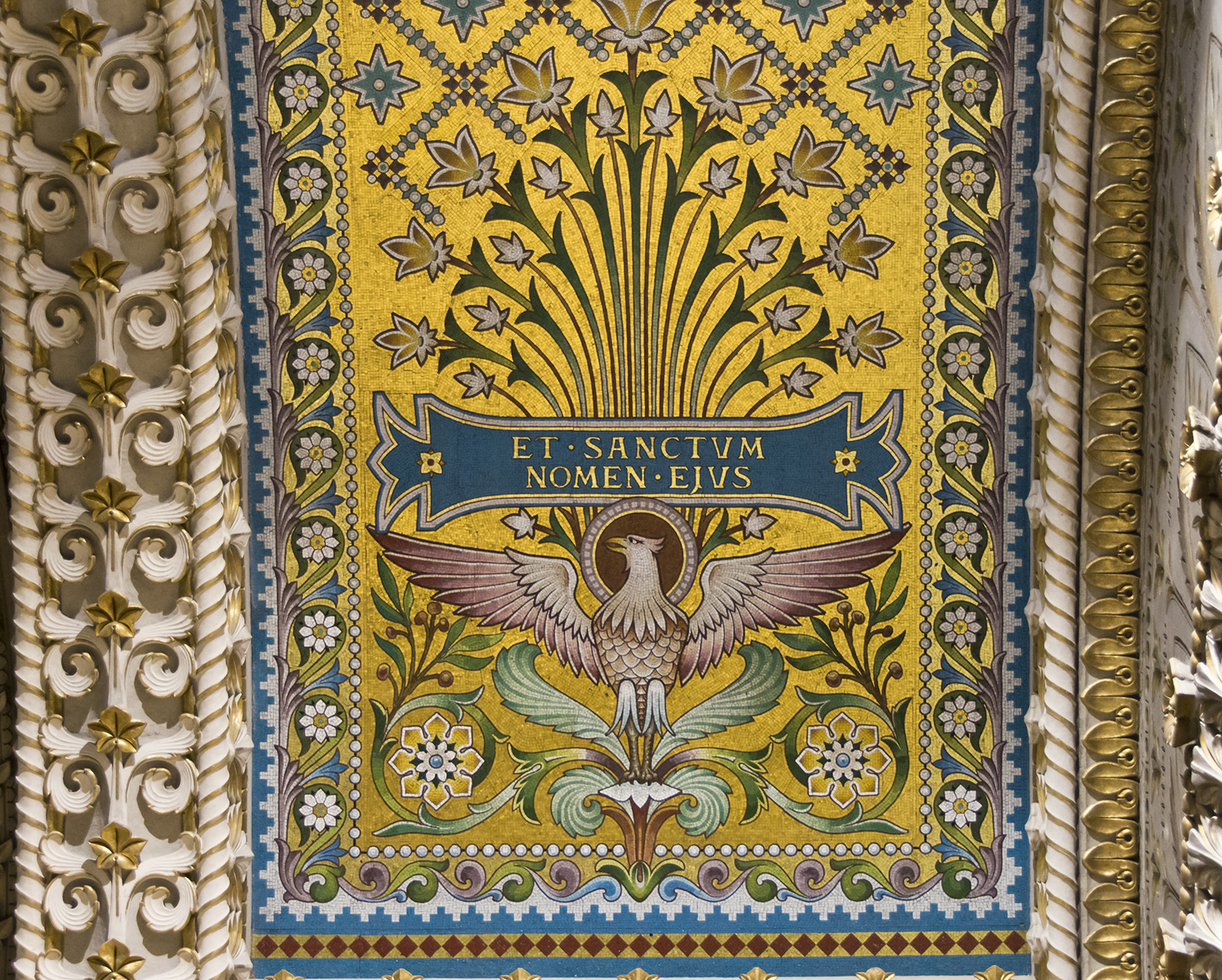 a colorful ceiling in the middle of the wall with gold and blue decor