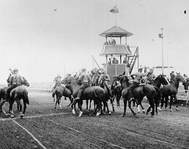 black and white image of several people riding horses