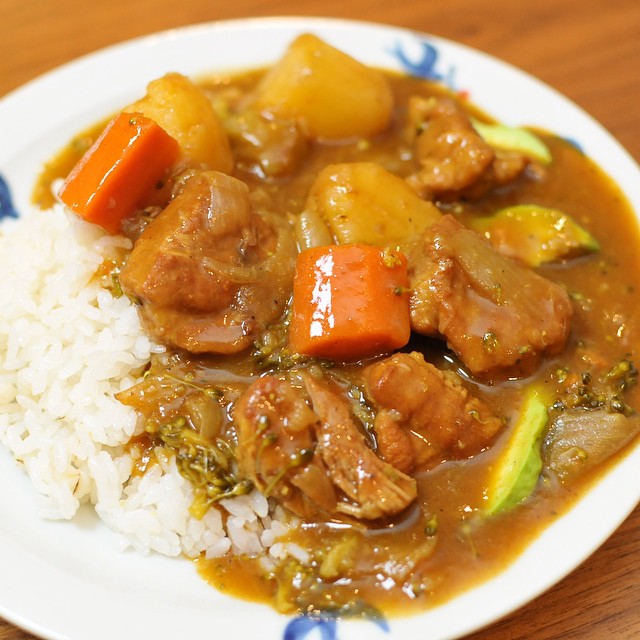 a white plate topped with rice and meat