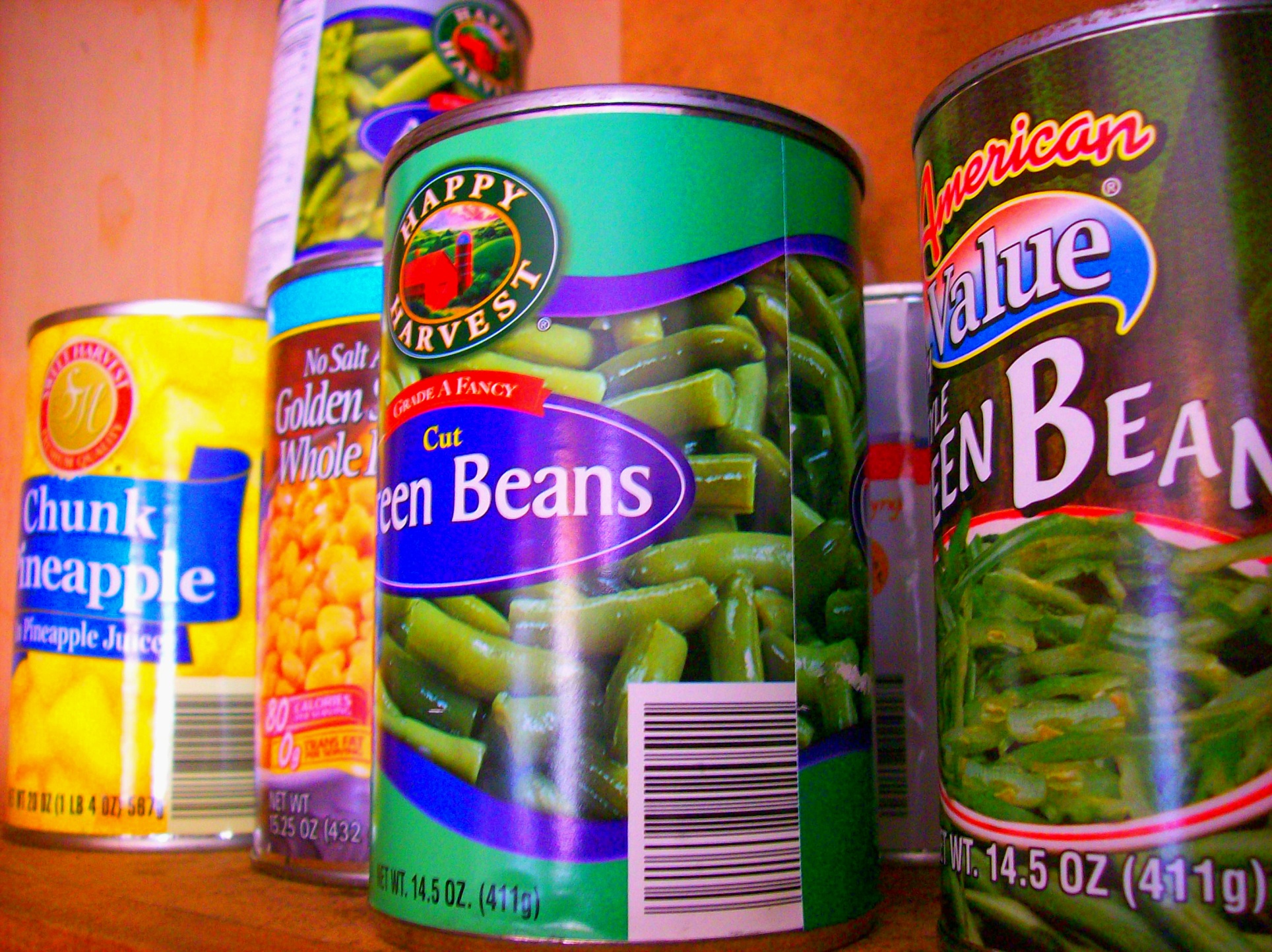 canned beans sit in cans on the shelf