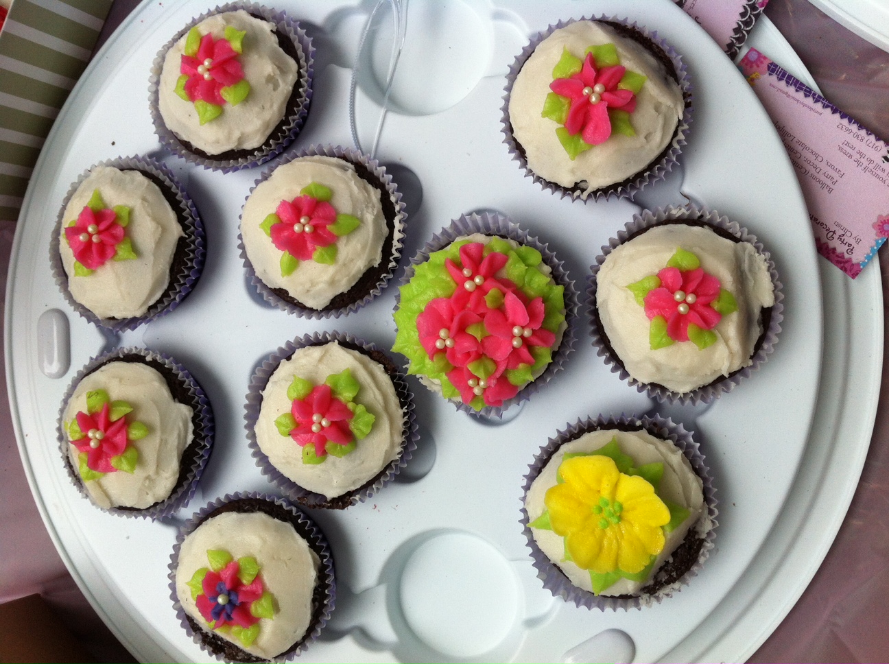 a plate with some cupcakes and a cupcake cutter on it