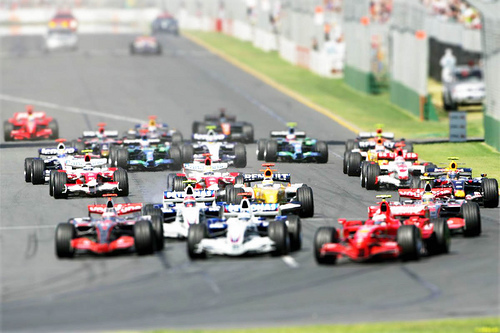 a group of race cars in a line on the track