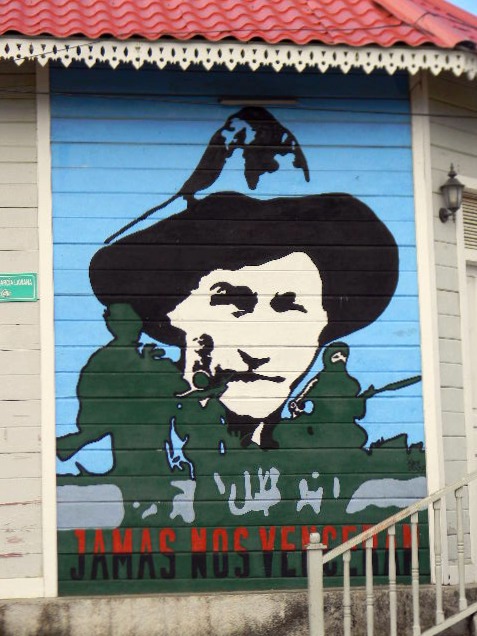 a painting of a man in a hat on the side of a building