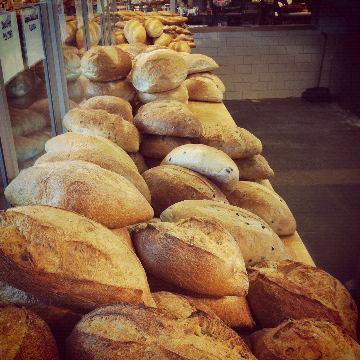 breads sitting on a shelf in a store