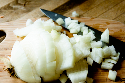 chopped onion and onions being cut on a  board