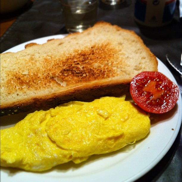 a close up of a plate of food with bread and eggs