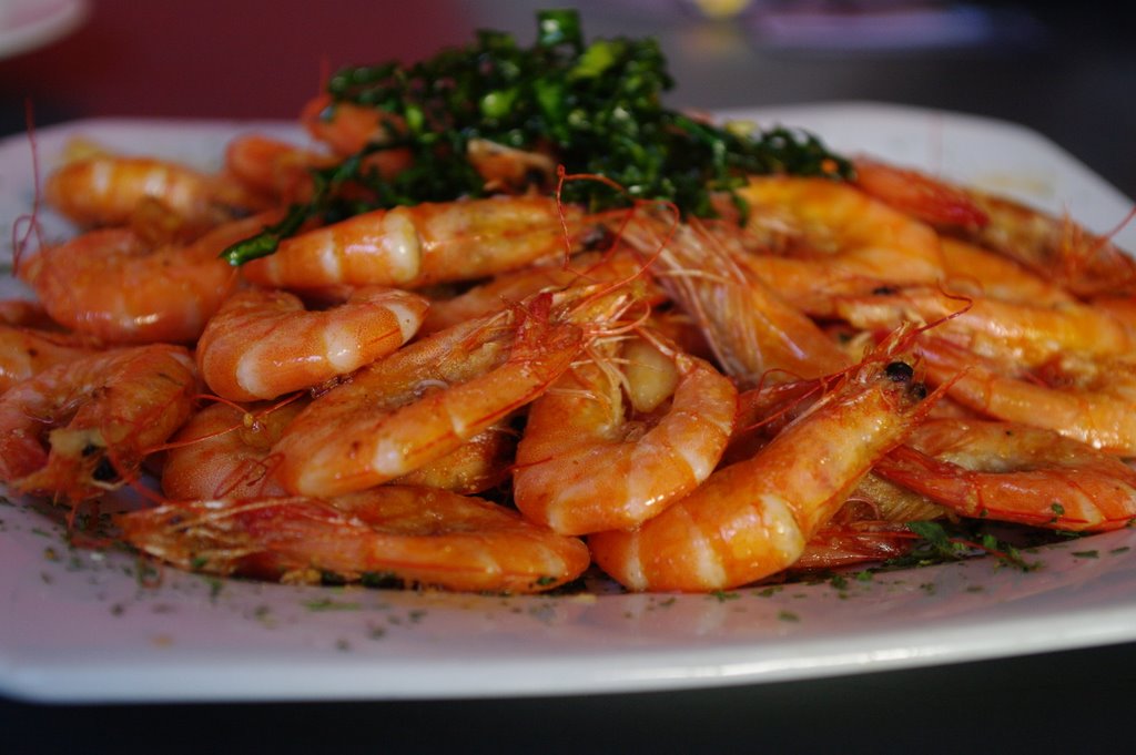 a pile of shrimp with herbs on top of it
