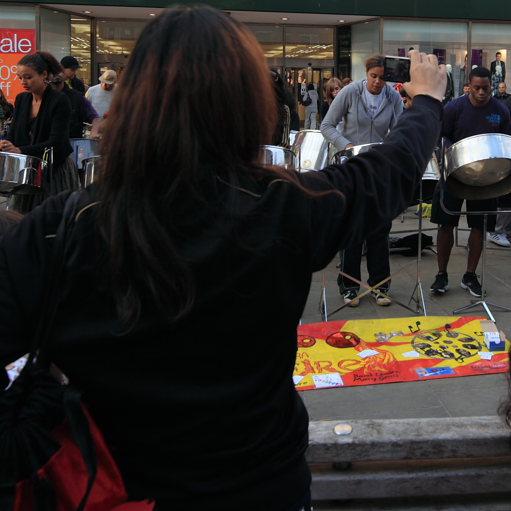 a man with a crowd of people outside of a store