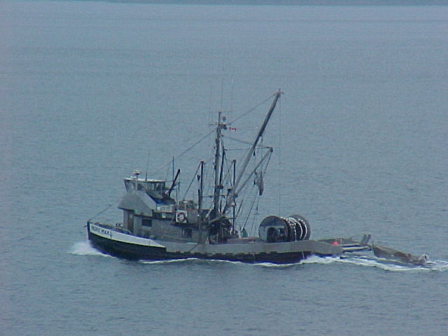the fishing boat is travelling across the water