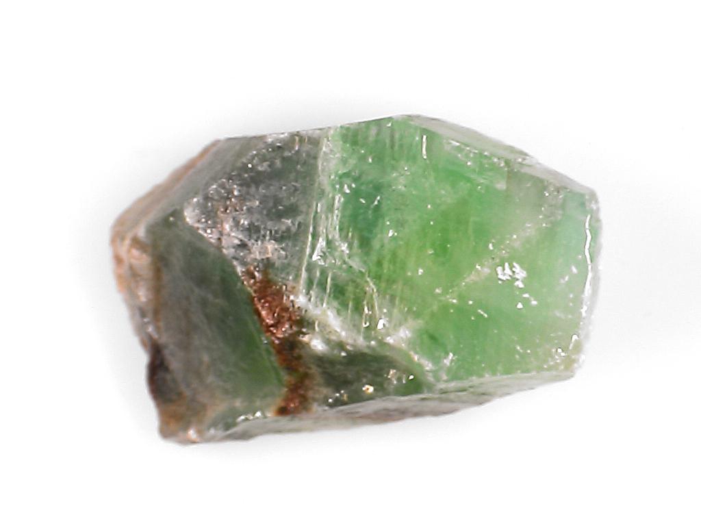 a large piece of green stone sitting on top of a white table