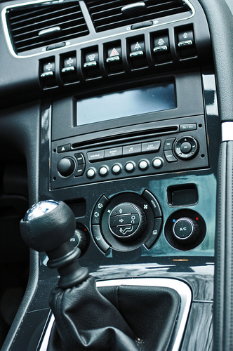 a picture of a car radio with steering wheel and dash board