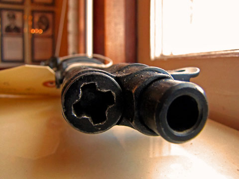 a close up of the top part of an old style black rifle