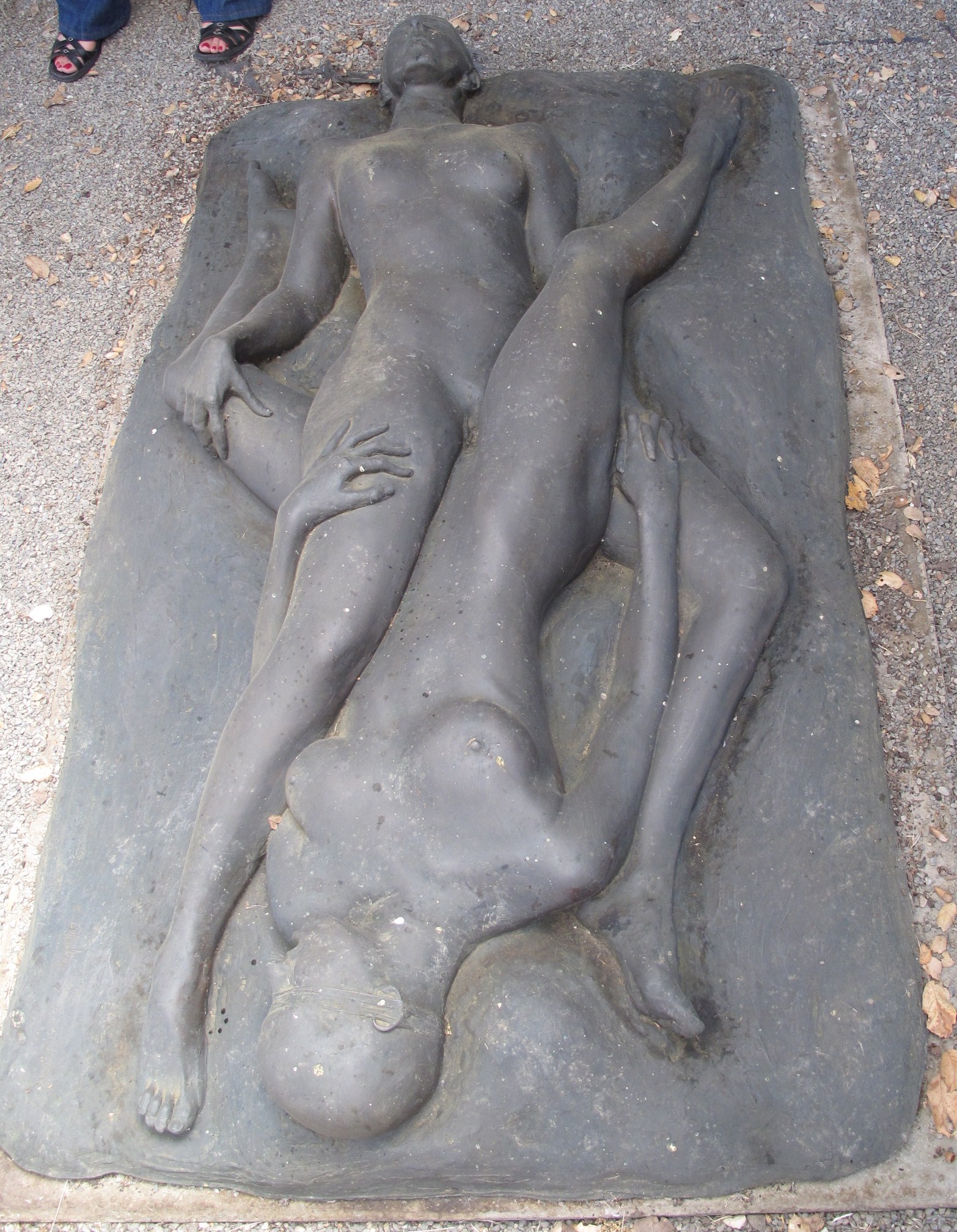 the statue is laid out outside on the sidewalk