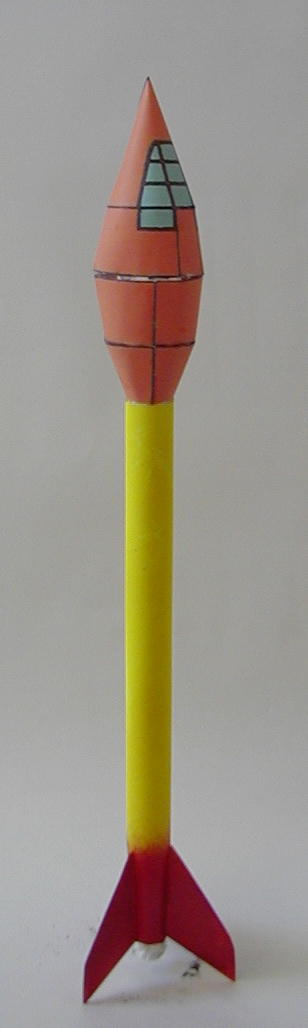 a wooden toy model of a rocket with a small section to the bottom