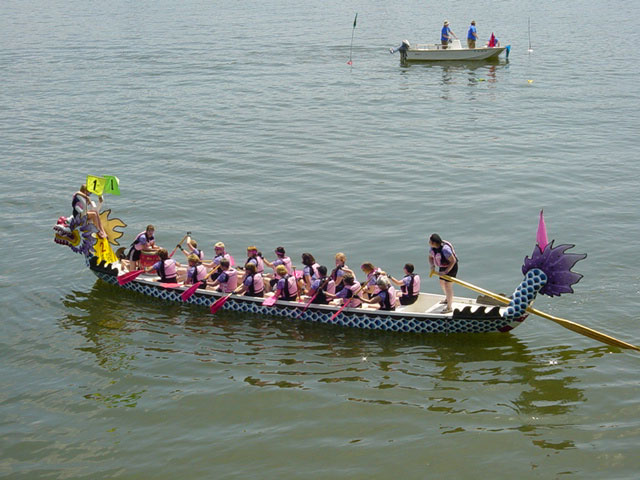 the dragon boat is painted bright pink and purple