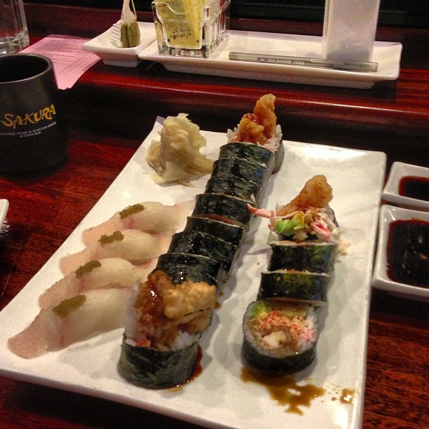a very long sushi roll is served on a plate