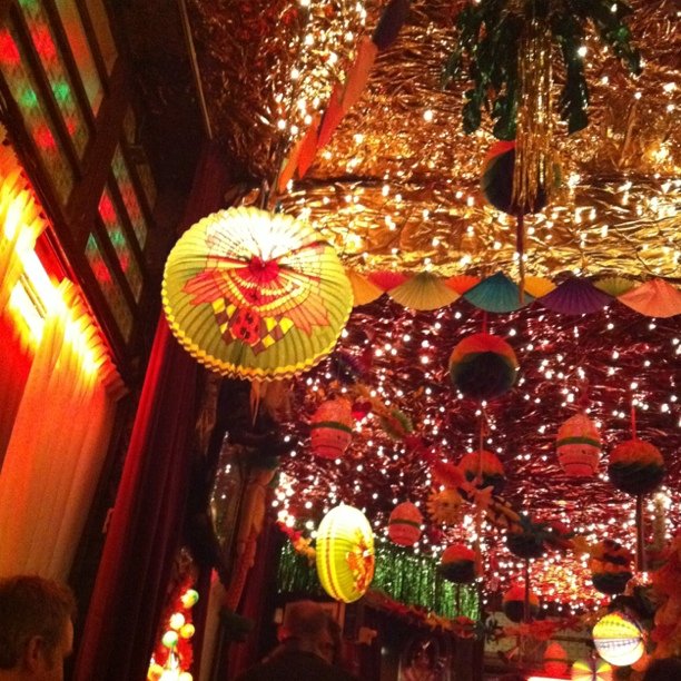the view of an oriental restaurant that is decorated with lanterns and lights