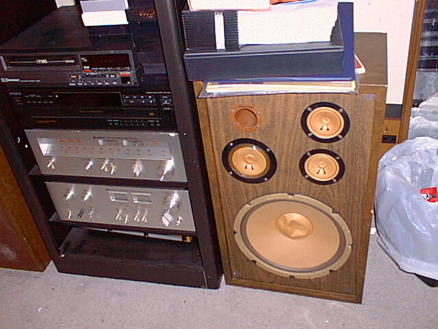 a stereo with wooden speakers and other electronic equipment