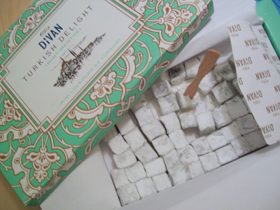 two boxes and several pieces of white cake