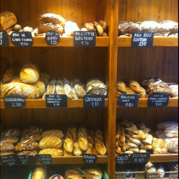 this bakery display has many types of bread on it