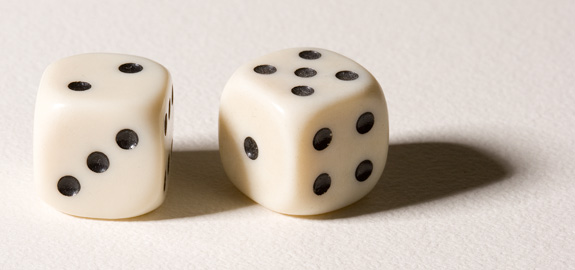 two white dices facing one another, both with black spots
