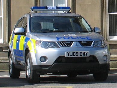 a police vehicle is parked in front of a building