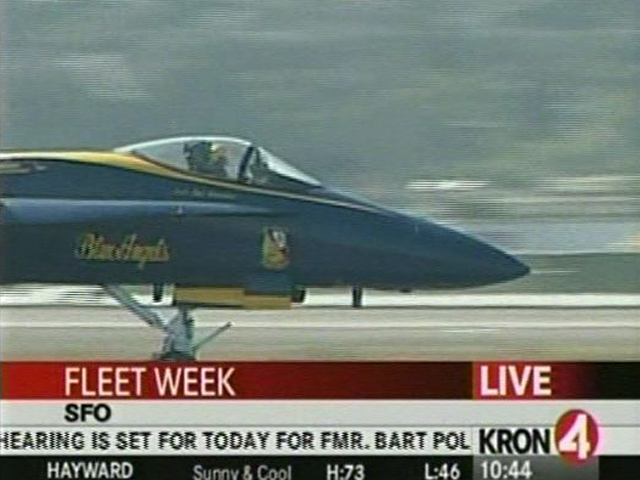 a blue fighter jet is shown on a tv screen