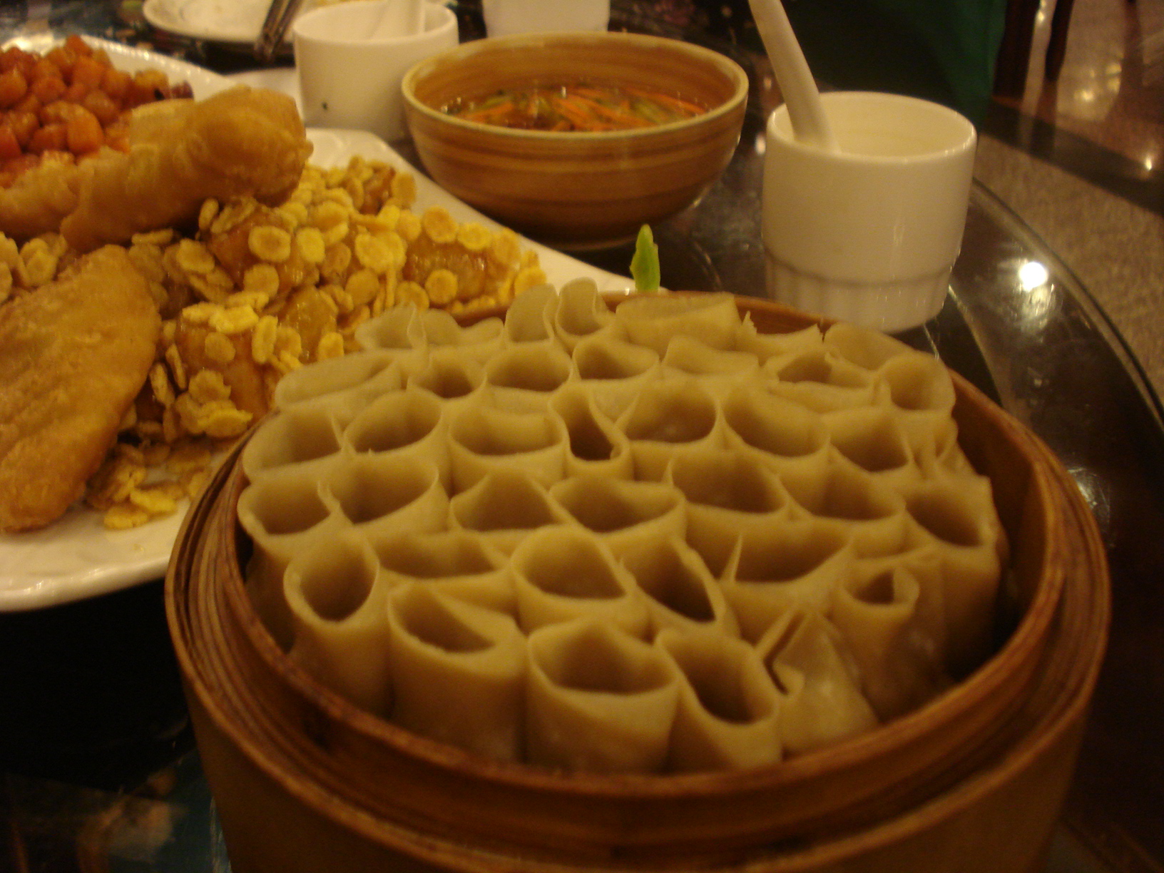 three large bowls of food at a table