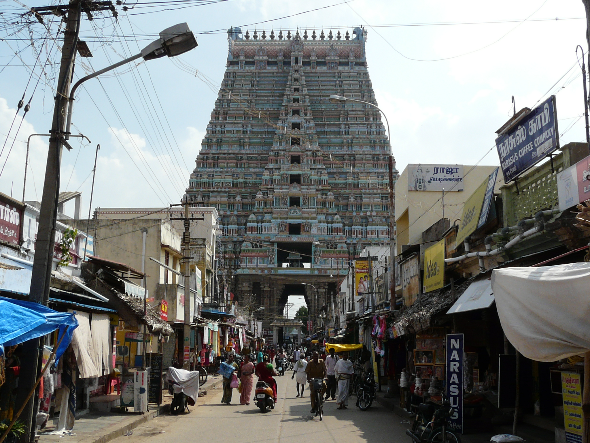 a view of a tall tower structure over a market area