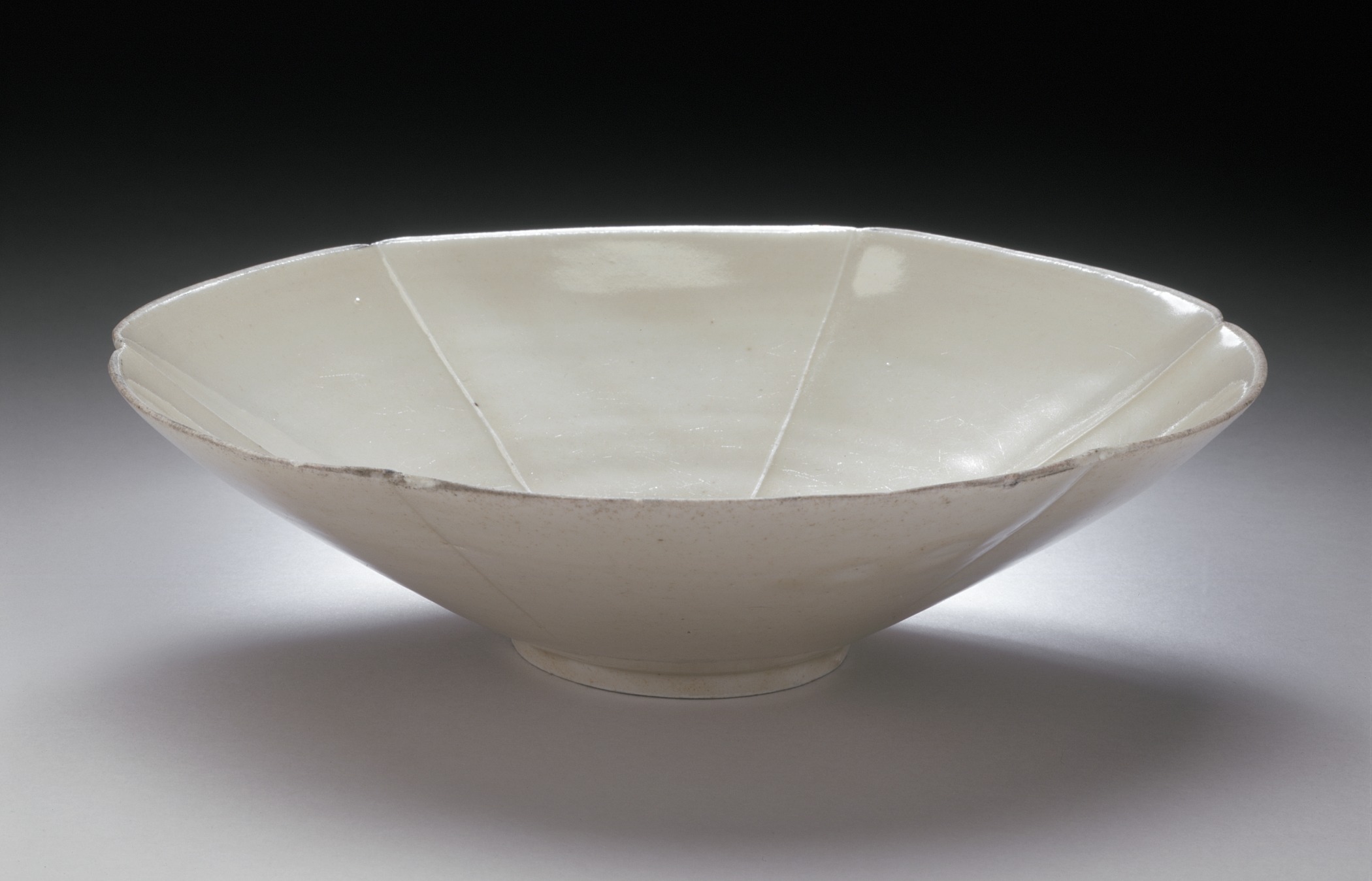 an empty white bowl on a white surface